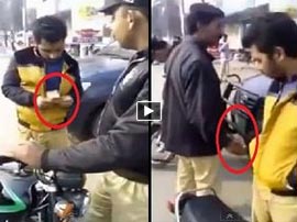 Police officer caught taking bribe from a man on motor bike